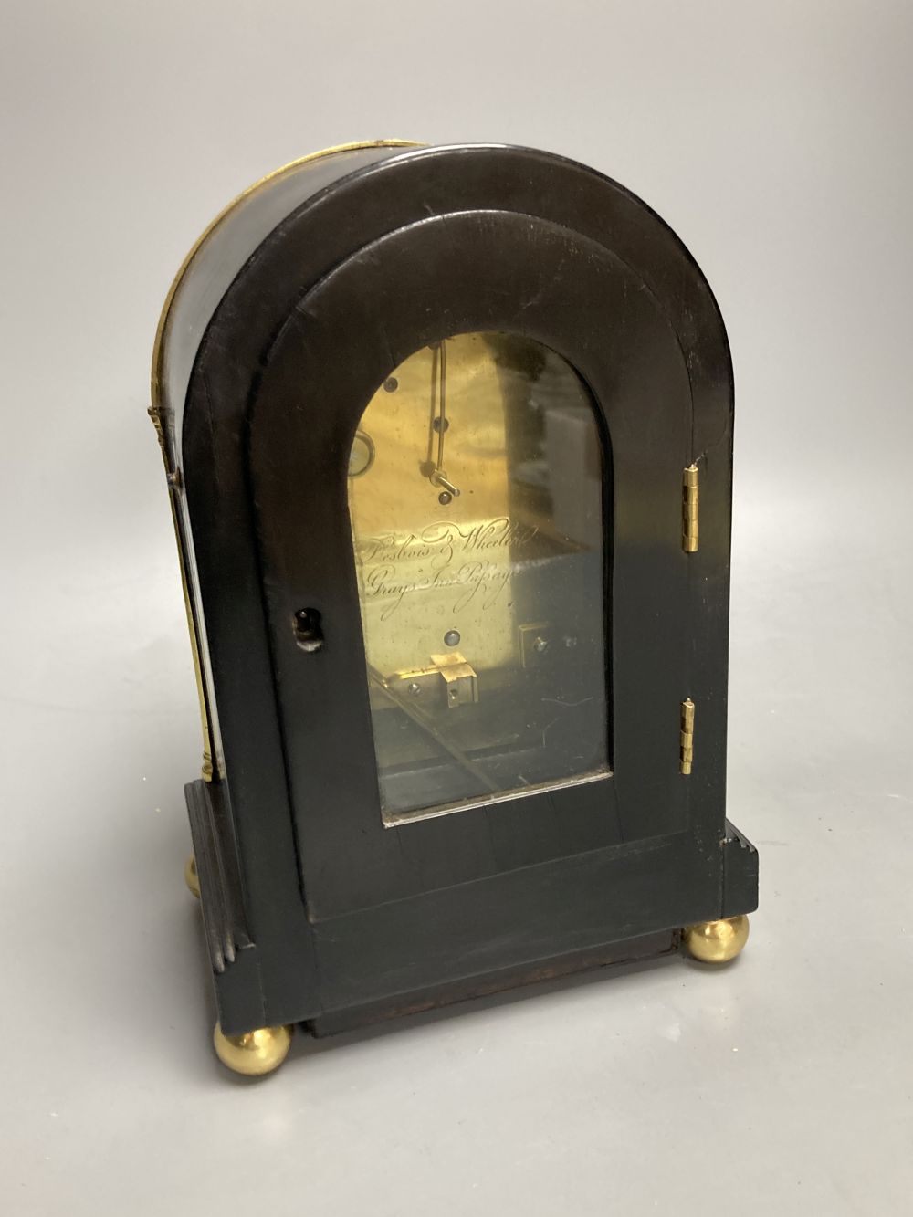 An early 19th century Desbois and Wheeler mahogany mantel timepiece, ebonised case with brass mounts, 9.5cm convex enamel dial, back-pl